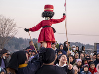 Young puppeteers perform with an Iranian traditional puppet during a pomegranate festival on Yalda Night Eve in the Abasabad tourism zone in...