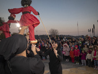 Young puppeteers perform with two Iranian traditional puppets during a pomegranate festival on Yalda Night Eve in the Abasabad tourism zone...