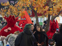 Young Iranian women pose for a photograph in front of pomegranate and watermelon-shaped dolls during a pomegranate festival on Yalda Night E...