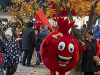 Iranian families pose for photographs with pomegranate and watermelon-shaped dolls during a pomegranate festival on Yalda Night Eve in the A...