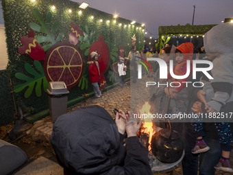 Young Iranian girls pose for photographs in front of Yalda decorations during a pomegranate festival on Yalda Night Eve in the Abasabad tour...