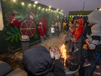 Young Iranian girls pose for photographs in front of Yalda decorations during a pomegranate festival on Yalda Night Eve in the Abasabad tour...