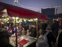 Young Iranian people wait to receive pomegranate ice cream while visiting a pomegranate festival on Yalda Night Eve in the Abasabad tourism...