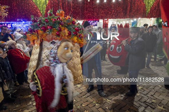 Iranian street musicians and performers play Iranian traditional music and dance during a pomegranate festival on Yalda Night Eve in the Aba...