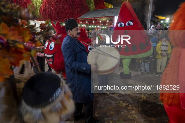 Iranian street musicians and performers play Iranian traditional music and dance during a pomegranate festival on Yalda Night Eve in the Aba...