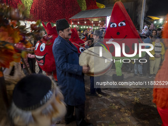 Iranian street musicians and performers play Iranian traditional music and dance during a pomegranate festival on Yalda Night Eve in the Aba...