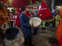 Iranian street musicians and performers play Iranian traditional music and dance during a pomegranate festival on Yalda Night Eve in the Aba...