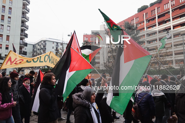 Demonstrators participate in the 62nd Saturday of the demonstration in support of Palestine in the Corvetto district in Milan, Italy, on Dec...