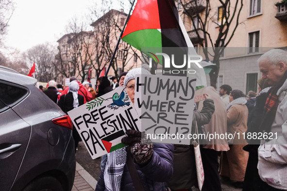 Demonstrators participate in the 62nd Saturday of the demonstration in support of Palestine in the Corvetto district in Milan, Italy, on Dec...