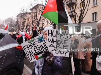 Demonstrators participate in the 62nd Saturday of the demonstration in support of Palestine in the Corvetto district in Milan, Italy, on Dec...