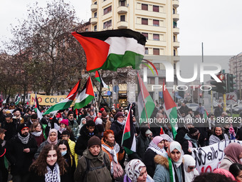 Demonstrators participate in the 62nd Saturday of the demonstration in support of Palestine in the Corvetto district in Milan, Italy, on Dec...