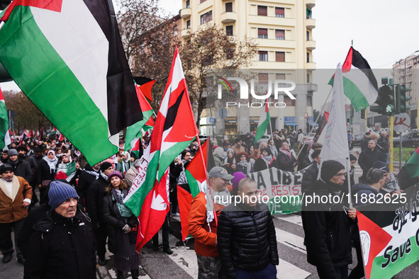 Demonstrators participate in the 62nd Saturday of the demonstration in support of Palestine in the Corvetto district in Milan, Italy, on Dec...