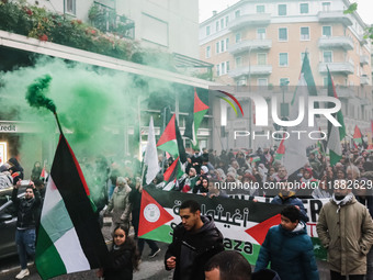 Demonstrators participate in the 62nd Saturday of the demonstration in support of Palestine in the Corvetto district in Milan, Italy, on Dec...