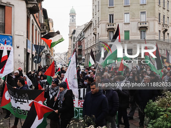 Demonstrators participate in the 62nd Saturday of the demonstration in support of Palestine in the Corvetto district in Milan, Italy, on Dec...