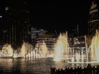 Tourists watch a water show of the Dubai Fountain at Burj Khalifa Lake in Dubai, United Arab Emirates on November 29, 2023.  (