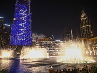 Tourists watch a water show of the Dubai Fountain at Burj Khalifa Lake in Dubai, United Arab Emirates on November 29, 2023.  (