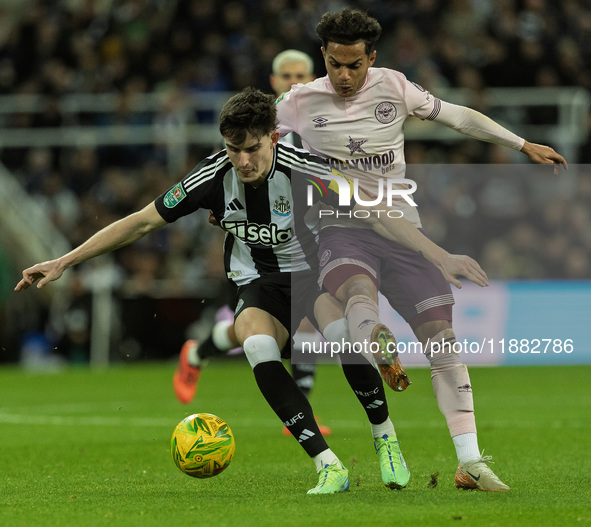 Tino Livramento of Newcastle United holds off Fabio Carvalho of Brentford during the Carabao Cup Quarter Final match between Newcastle Unite...