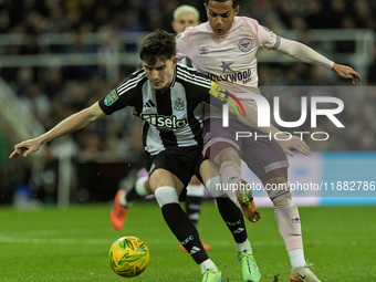 Tino Livramento of Newcastle United holds off Fabio Carvalho of Brentford during the Carabao Cup Quarter Final match between Newcastle Unite...