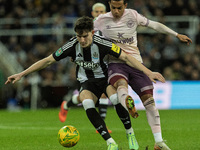 Tino Livramento of Newcastle United holds off Fabio Carvalho of Brentford during the Carabao Cup Quarter Final match between Newcastle Unite...