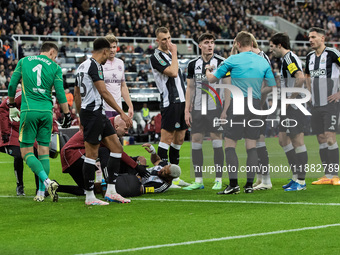 Newcastle United's Joelinton receives treatment for a facial wound during the Carabao Cup Quarter Final match between Newcastle United and B...