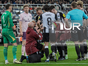 Newcastle United's Joelinton receives treatment for a facial wound during the Carabao Cup Quarter Final match between Newcastle United and B...