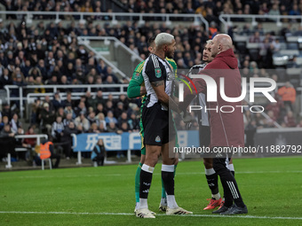 Newcastle United's Joelinton receives treatment for a facial wound during the Carabao Cup Quarter Final match between Newcastle United and B...