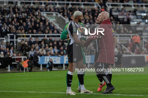 Newcastle United's Joelinton receives treatment for a facial wound during the Carabao Cup Quarter Final match between Newcastle United and B...