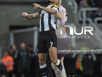 Joelinton of Newcastle United challenges Nathan Collins of Brentford for a header during the Carabao Cup Quarter Final match between Newcast...