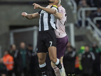 Joelinton of Newcastle United challenges Nathan Collins of Brentford for a header during the Carabao Cup Quarter Final match between Newcast...