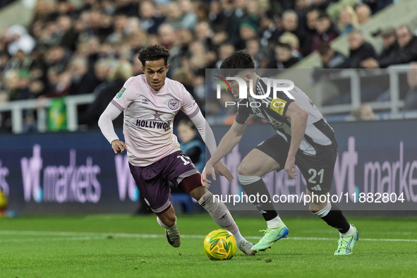 Tino Livramento of Newcastle United competes with Fabio Carvalho of Brentford during the Carabao Cup Quarter Final match between Newcastle U...