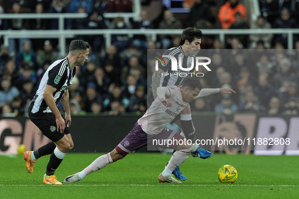 Sandro Tonali of Newcastle United battles for possession with Brentford's Fabio Carvalho during the Carabao Cup Quarter Final match between...