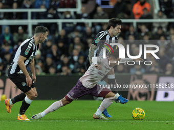 Sandro Tonali of Newcastle United battles for possession with Brentford's Fabio Carvalho during the Carabao Cup Quarter Final match between...