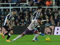 Sandro Tonali of Newcastle United battles for possession with Brentford's Fabio Carvalho during the Carabao Cup Quarter Final match between...