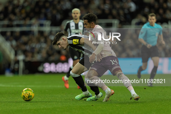 Tino Livramento of Newcastle United holds off Fabio Carvalho of Brentford during the Carabao Cup Quarter Final match between Newcastle Unite...