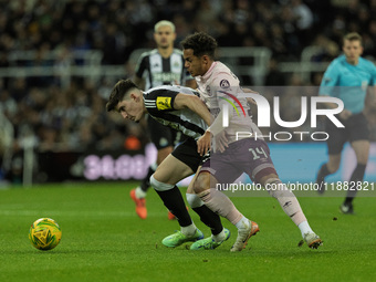 Tino Livramento of Newcastle United holds off Fabio Carvalho of Brentford during the Carabao Cup Quarter Final match between Newcastle Unite...