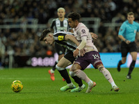 Tino Livramento of Newcastle United holds off Fabio Carvalho of Brentford during the Carabao Cup Quarter Final match between Newcastle Unite...