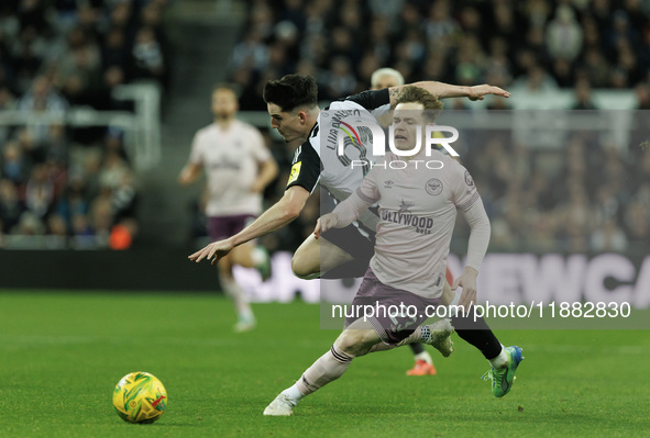 Tino Livramento of Newcastle United is in action with Brentford's Keane Lewis-Potter during the Carabao Cup Quarter Final match between Newc...