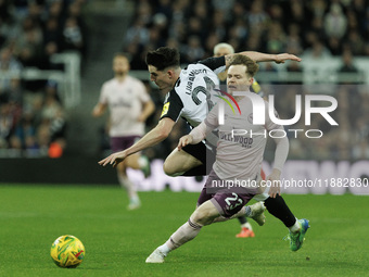 Tino Livramento of Newcastle United is in action with Brentford's Keane Lewis-Potter during the Carabao Cup Quarter Final match between Newc...