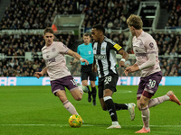 Newcastle United's Joe Willock is in action with Brentford's Mads Roerslev and Yehor Yarmolyuk during the Carabao Cup Quarter Final match be...