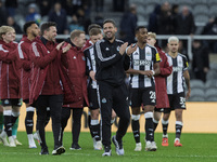 Newcastle United's assistant manager Jason Tindall (in a black tracksuit) applauds their fans after the Carabao Cup Quarter Final match betw...