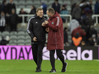 Newcastle United manager Eddie Howe and assistant manager Graeme Jones applaud their supporters after the Carabao Cup Quarter Final match be...