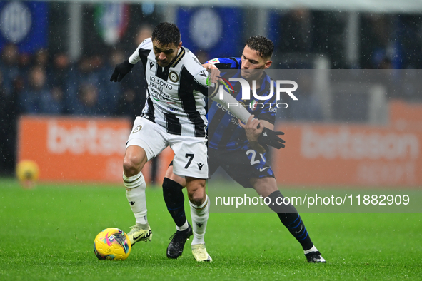 Alexis Sanchez of Udinese Calcio and Kristjan Aslani of Inter Milan battle for the ball during the Coppa Italia Frecciarossa match between I...