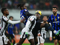 Yann Aurel Bisseck of Inter Milan and Hassane Kamara of Udinese Calcio battle for the ball during the Coppa Italia Frecciarossa match betwee...