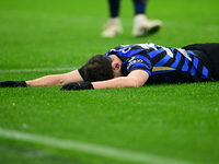 Carlos Augusto of Inter Milan lies on the ground during the Coppa Italia Frecciarossa match between Inter Milan and Udinese Calcio at Giusep...