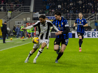 Arthur Atta and Alessandro Bastoni are in action during the Coppa Italia match between FC Internazionale and Udinese Calcio at Giuseppe Meaz...