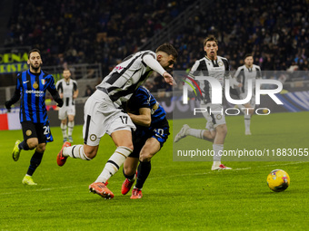 Lorenzo Lucca and Carlos Augusto play during the Coppa Italia match between FC Internazionale and Udinese Calcio at Giuseppe Meazza Stadium...