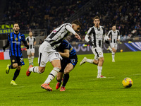 Lorenzo Lucca and Carlos Augusto play during the Coppa Italia match between FC Internazionale and Udinese Calcio at Giuseppe Meazza Stadium...