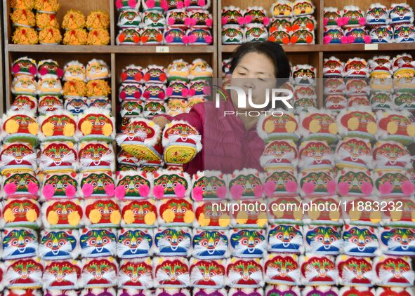 A craftsman arranges tigerhead shoes in Lizhuang village, Zhangxibao town, Yongnian district, Handan city, North China's Hebei province, on...