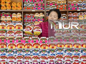 A craftsman arranges tigerhead shoes in Lizhuang village, Zhangxibao town, Yongnian district, Handan city, North China's Hebei province, on...