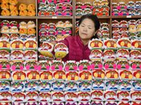 A craftsman arranges tigerhead shoes in Lizhuang village, Zhangxibao town, Yongnian district, Handan city, North China's Hebei province, on...